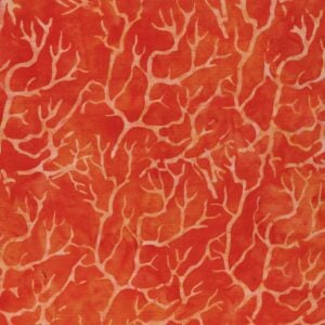 an image of orange fabric with a pattern of lighter orange branches