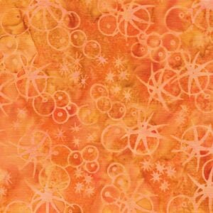 an image of orange batik fabric with a pattern of scattered sea urchin outlines in lighter orange