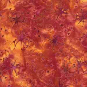 an image of red-orange batik fabric with a pattern of scattered sea urchin outlines in reddish pink