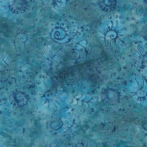 an image of blue-gray batik fabric with a pattern of scattered blue seaweed and leaf shapes