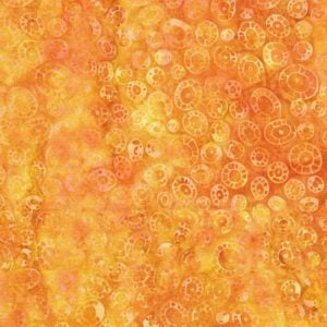 an image of yellow and gold batik fabric with a pattern of scattered amoeba shapes
