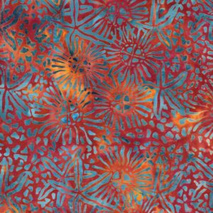 an image of red orange batik fabric with a pattern of scattered starfish outlines in teal