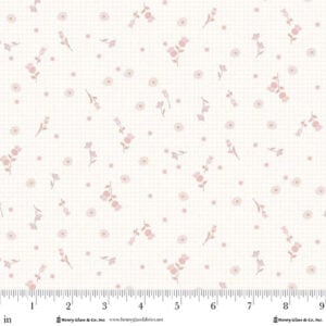 an image of white fabric with a light cream checkboard background and a pattern of tossed thistles
