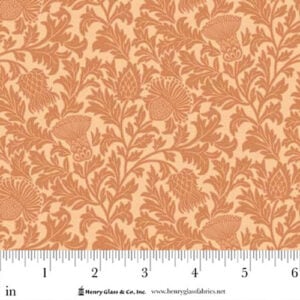 an image of yellow fabric with an all-over pattern of orange thistles