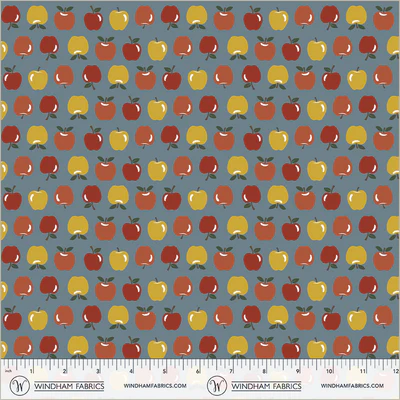 an image of blue fabric with a pattern of rows of small yellow, orange, and red apples