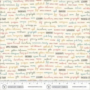 an image of off-white fabric with a pattern of rows of apple-related words in blue, green, black, and red