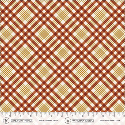 an image of white fabric with a pattern of red and gold plaid that runs diagonally to the selvedge