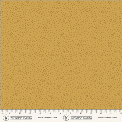 an image of yellow fabric with a pattern of tossed small irregular triangles