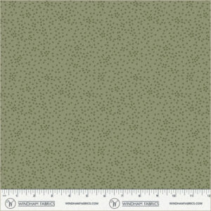 an image of green fabric with a pattern of tossed small irregular triangles