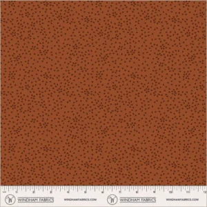 an image of rust fabric with a pattern of tossed small irregular triangles