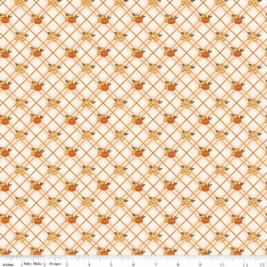 an image of cream colored fabric with a pattern of diagonal plaid and small pumpkins in orange and gold