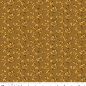 an image of golden brown fabric with a pattern of tossed sprigs of bittersweet