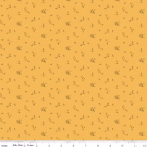 an image of yellow fabric with a pattern of tossed floral sprigs
