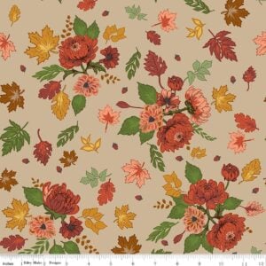 an image of light tan fabric with a pattern of tossed clusters of leaves and flowers in rust, coral, and gold