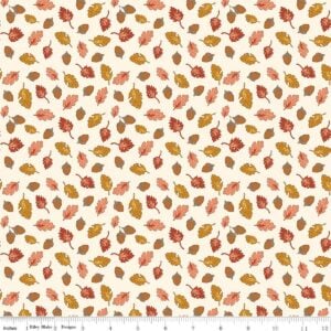 an image of off-white fabric with a pattern of tossed acorns and fall leaves