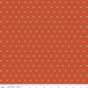 an image of orange fabric with a pattern of acorns arranged in clusters of 4 with their hats pointed outward