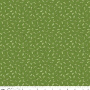 an image of green fabric with a pattern of small tossed leaf sprigs in off-white