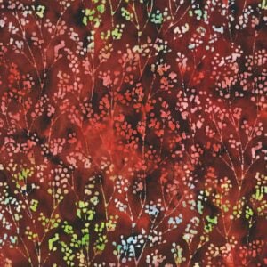 an image of red fabric with a pattern of lighter multicolored sprigs