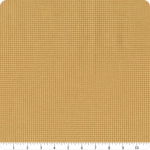 an image of gold and tan fabric with a houndstooth pattern