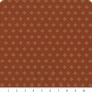 an image of reddish brown fabric with a pattern of acorns arranged in clusters of 4 with their hats pointed outward