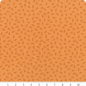 an image of orange fabric with a pattern of small tossed leaf sprigs in darker orange