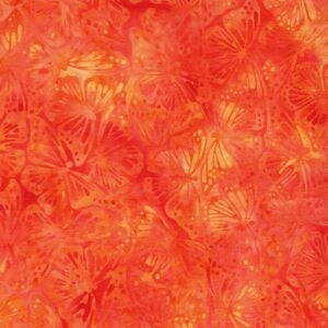 an image of orange batik fabric with an allover pattern of monarch butterflies