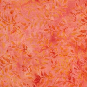 an image of light orange batik fabric with an allover pattern of leaves and vines