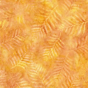 an image of yellow batik fabric with an allover print of tonal fern leaves