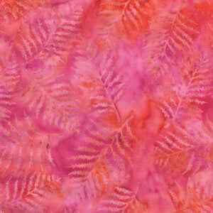 an image of pink and orange batik fabric with an allover print of tonal fern leaves