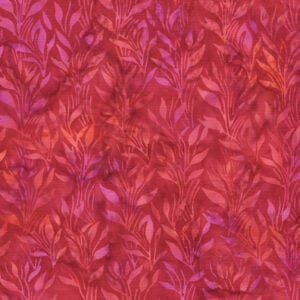 an image of magenta, red, and orange batik fabric with a tonal pattern of vines and leaves