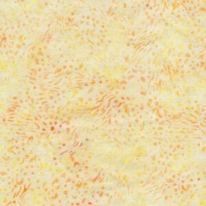 an image of light yellow batik fabric with a pattern of small dots and squiggles