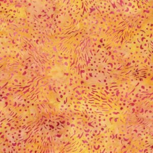 an image of yellow-orange batik fabric with a pattern of small pink dots and squiggles