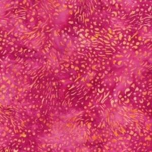 an image of dark pink batik fabric with a pattern of small yellow dots and squiggles