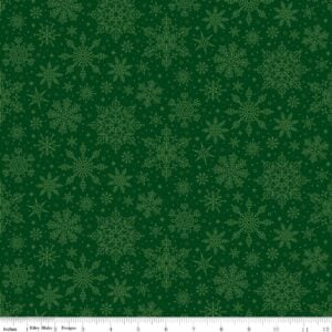an image of green fabric with a pattern of tossed lighter green snowflakes