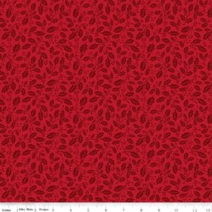 an image of red fabric with a pattern of small tossed holly sprigs