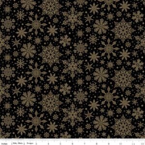 an image of black fabric with a pattern of tossed gold foil snowflakes