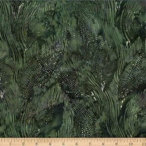 an image of green batik fabric with an allover pattern of grass and leaves