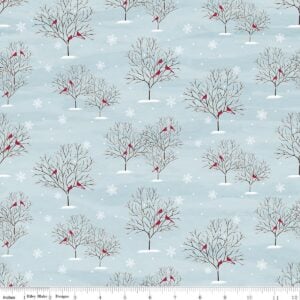 an image of light blue-gray fabric with a directional pattern of bare trees holding cardinals in winter
