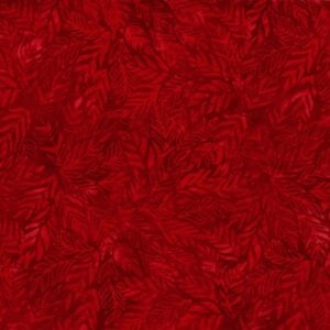 an image of red batik fabric with an allover tonal pattern of leaves